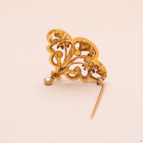 Broche vintage en or jaune ornée au de demi perle