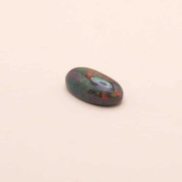 Cabochon d'opale verte avec reflets rouges et jaune